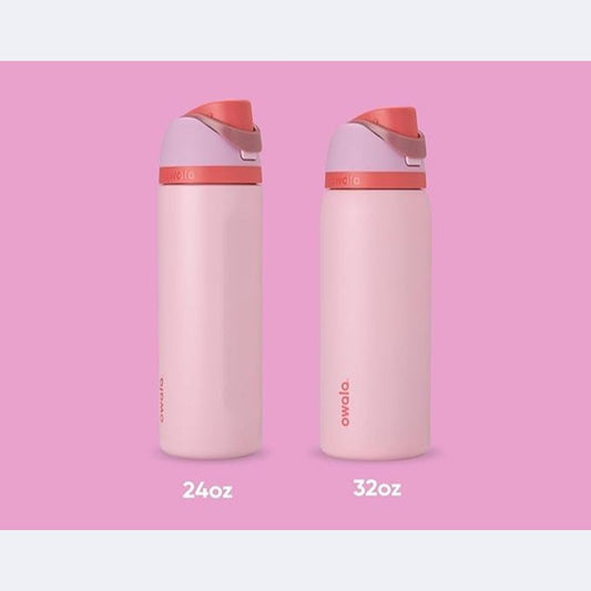 Owala FreeSip water bottles in pink colorway, shown in 24oz and 32oz sizes, against a pastel pink background